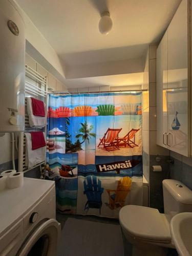 a bathroom with a shower with a colorful shower curtain at Velvet Living Luxury Apartment in Skopje