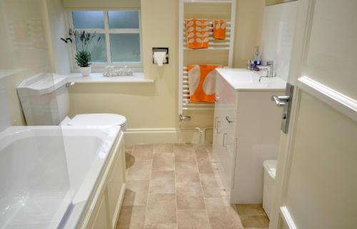a bathroom with a toilet and a sink at Rural Coastal Self-Catering Accommodation for 8, Near Sandringham Estate, Norfolk in Ingoldisthorpe