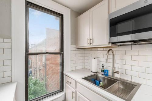 a kitchen with a sink and a window at Short north- STEPS to High St -Private Parking-OSU in Milo