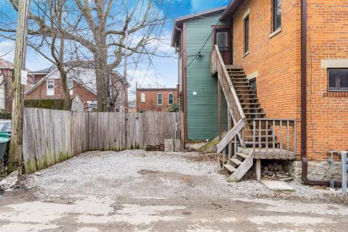 a house with a wooden fence and a wooden staircase at Short north- STEPS to High St -Private Parking-OSU in Milo