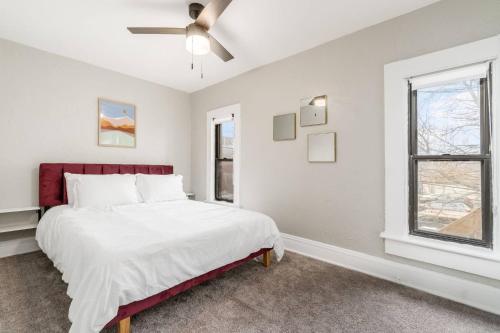 a white bedroom with a bed and a window at Short north- STEPS to High St -Private Parking-OSU in Milo