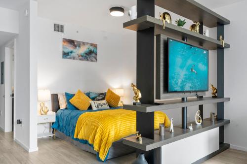 a bedroom with a bed and a flat screen tv at Penthouse Infinity heated pool and jacuzzi in Miami