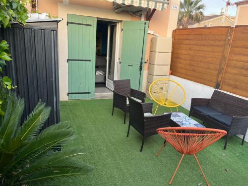 un groupe de chaises et une table sur une terrasse dans l'établissement Maison bord de mer, à La Seyne-sur-Mer