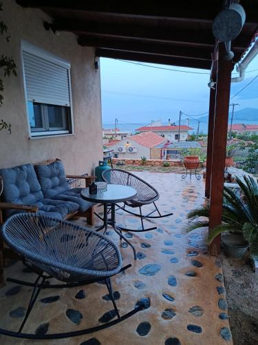 a patio with chairs and a couch and a table at zikos house in Monemvasia