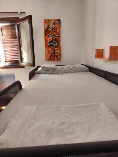 a bedroom with a large bed in a room at Hostel Banana Surf House in Los Cristianos