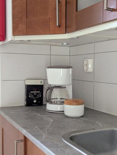 a kitchen counter with a coffee maker and a mixer at Cabin outside Sösdala in Sösdala