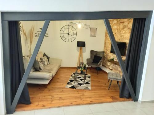 a living room with a couch and a table at Gîte de charme Abelia avec extérieur au calme in Lavaur