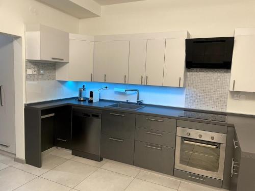 a kitchen with white cabinets and a sink at New place in Petřvald in Petřvald