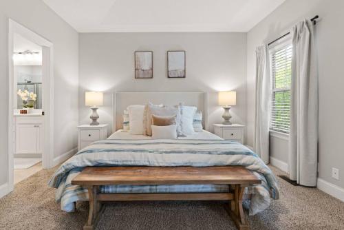 a white bedroom with a bed and two windows at Mariners Getaway in Saint Simon Mills