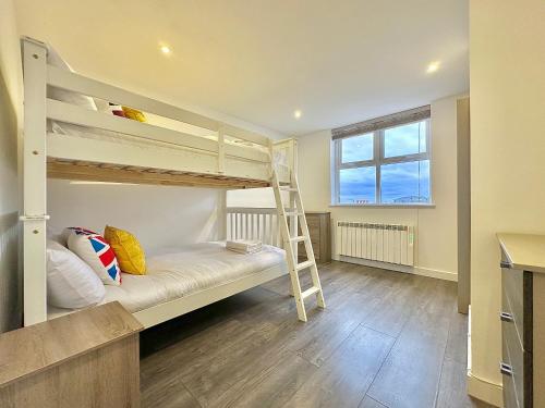 a room with two bunk beds and a ladder at Budget 29 in London