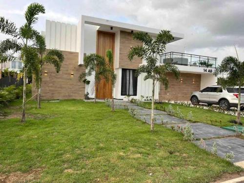 a house with a lawn in front of it at Elegant, Modern style Villa in Playa Nueva Romana2 in Boca del Soco