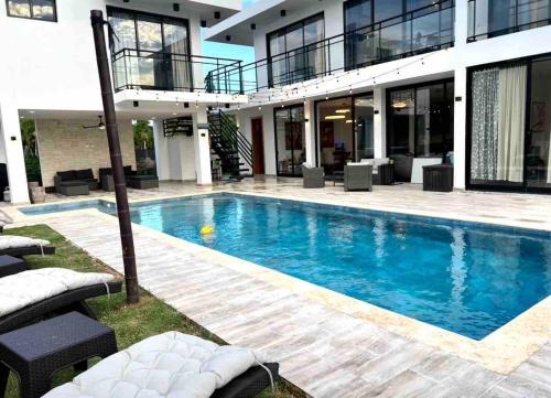 a large swimming pool in front of a building at Elegant, Modern style Villa in Playa Nueva Romana2 in Boca del Soco