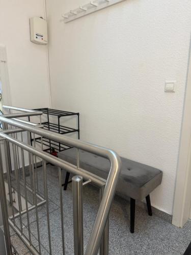 a hospital bed in a room with a railing at Über den Dächern von Werne - Balkon, WLAN, TV und Küche - Möller in Werne an der Lippe