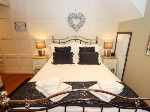 a bedroom with a bed with a heart on the wall at Gavel Cottage in Whitby