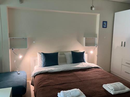 a bedroom with a large bed with blue pillows at The art place in Vidin