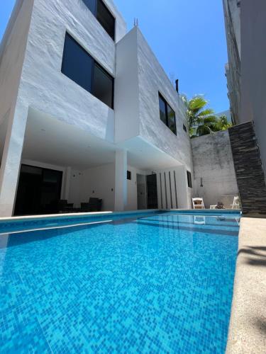 a swimming pool in front of a house at Alce33 in Cancún