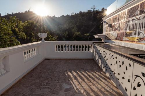 a balcony of a house with the sun in the background at Casa D'Agostino in Santiago