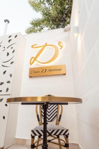 a table and a chair in front of a sign at Casa D'Agostino in Santiago