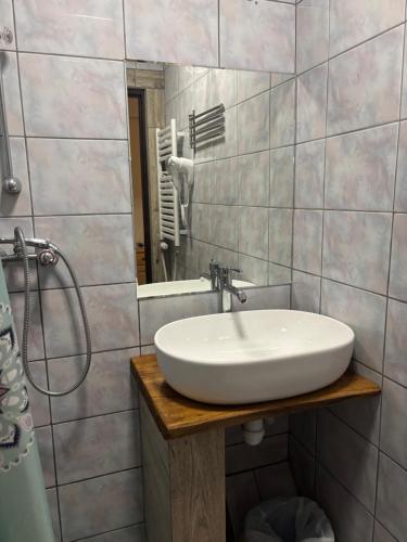 a bathroom with a white sink and a mirror at Ośrodek Vantur in Księże Młyny