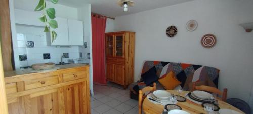 une cuisine avec une table et une salle à manger dans l'établissement Apt de charme 4 pers, vue port, location idéale, à Gruissan