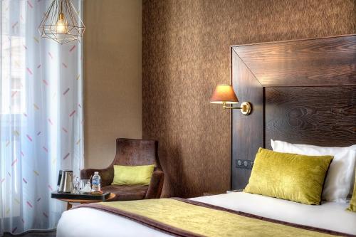 a hotel room with a bed and a chair at Best Western Plus Nice Cosy Hotel in Nice
