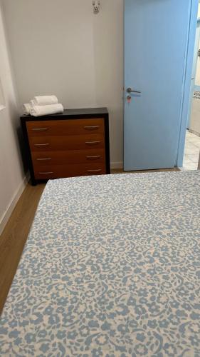 a bedroom with a bed and a dresser and a door at Sweet Dreams in Albufeira