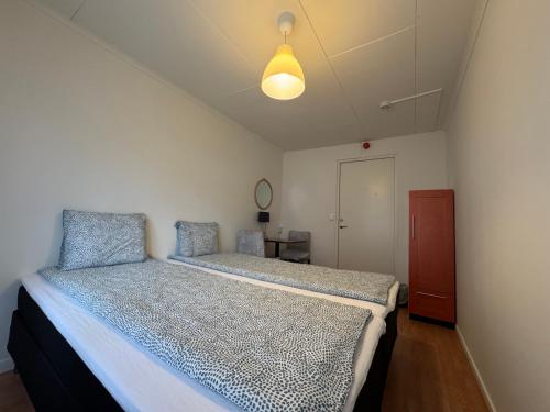 a bedroom with a bed and a ceiling at Hässlebogården Turist & Konferens in Mariannelund