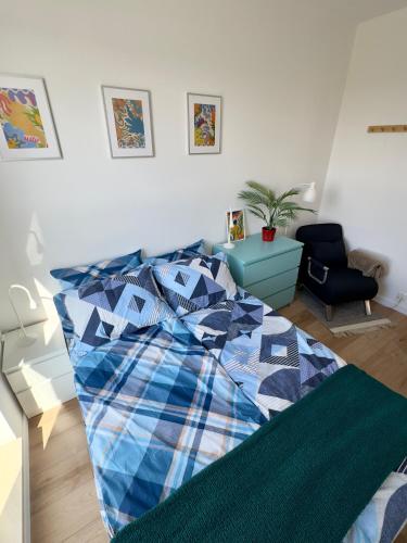 a bedroom with a bed with a blue at Navy Blue Apartment in Gdynia