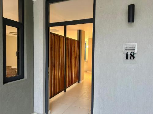 a hallway with a door with a number on it at One Roma by the Cubes in Lusaka