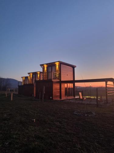 a house sitting on top of a grass field at Natura Bungalow in Ždrelo