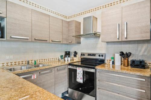 a kitchen with a stove and a sink at Palma Real 60 in Palm-Eagle Beach