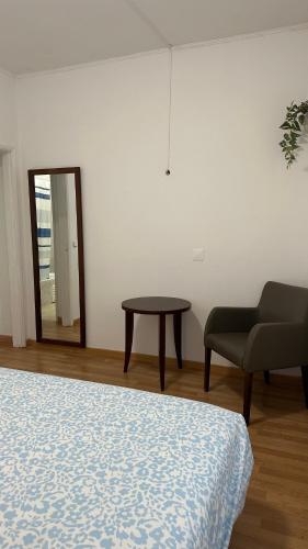 a room with a bed and a chair and a mirror at Sweet Dreams in Albufeira