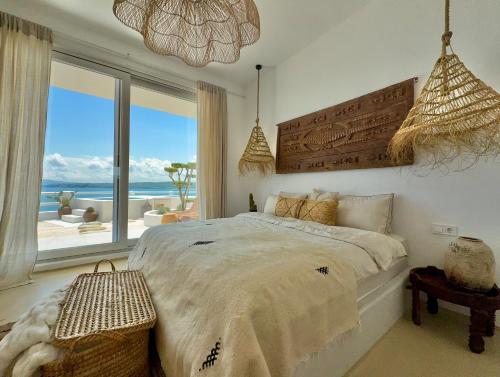 a bedroom with a bed with a view of the ocean at Casa de oro Lujo in Sozopol