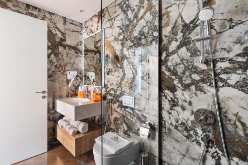 a bathroom with a shower and a toilet and a sink at qua Serenity Poolside with Community Views in Dubai