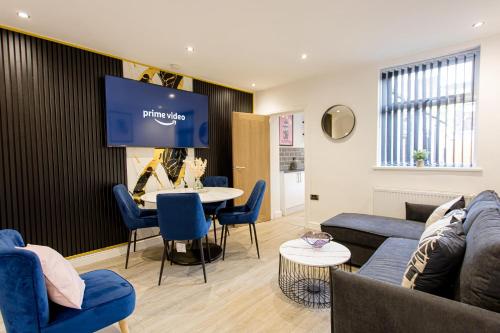 a living room with a couch and a table at Cosy Cruise Cribs - SEAFORD in Stoke on Trent