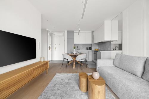 a living room with a couch and a table at Rezydencja Merwede Aparthotel - My Rest in Gdańsk