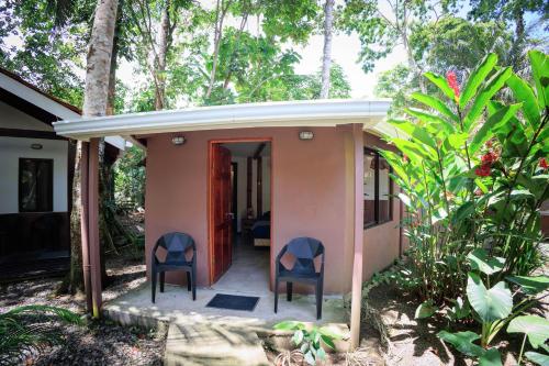two chairs sitting on the porch of a house at Bambutel Cocles in Puerto Viejo