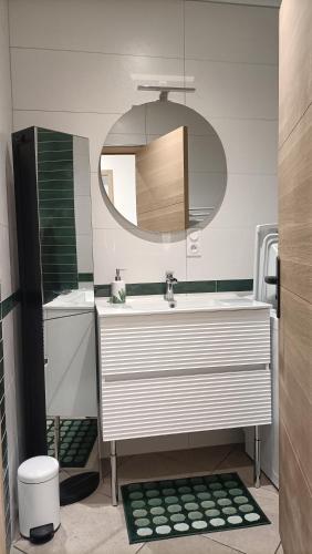 une salle de bain avec un lavabo et un miroir dans l'établissement Home 18, à Tavaux