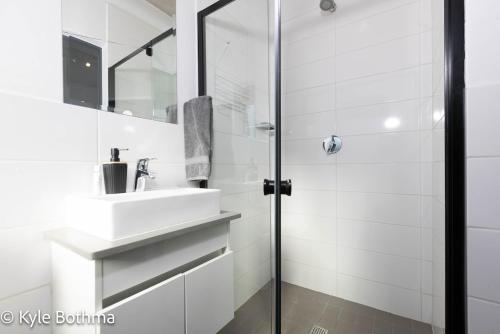 a bathroom with a sink and a shower at Smart Apartment Luxury in Midrand