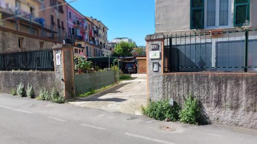 an empty street with a fence on the side of a building at affittacamere IL GIARDINO la spezia cinque terre in La Spezia