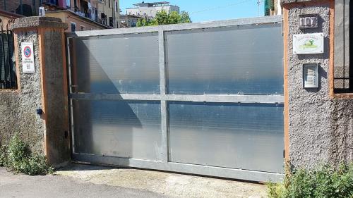 a large metal garage door in a brick building at affittacamere IL GIARDINO la spezia cinque terre in La Spezia
