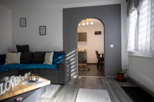 a living room with a blue couch and a table at Ferienhaus Pottschach in Pottschach