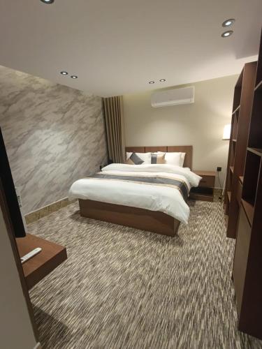 a large hotel room with two beds in it at Medad Apartments Al Hamra in Al Khobar