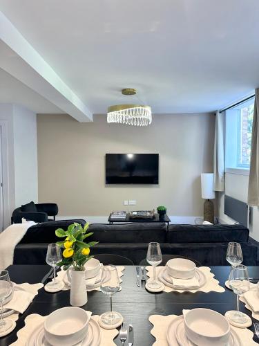 a living room with a table with plates and wine glasses at Fully Furnished Flat By Ankers Short Term Rental Stockport Perfect for Contractors in Stockport