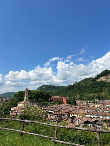 a view of a town from a hill with a fence at Casa Leopoldo in Ceva