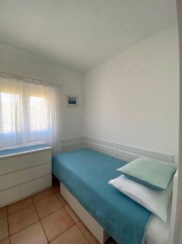 a bedroom with a blue bed with a window at House Feniks, 2 bedrooms, private parking, Starlink! in Milna