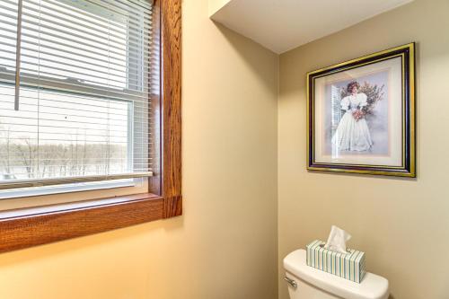a bathroom with a picture on the wall and a toilet at Lakefront Family Home with Boat Dock in Underwood in Battle Lake