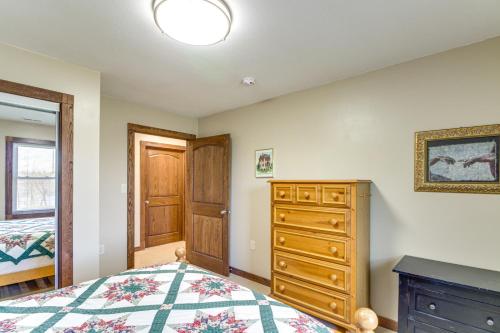 a bedroom with a bed and a wooden dresser at Lakefront Family Home with Boat Dock in Underwood in Battle Lake