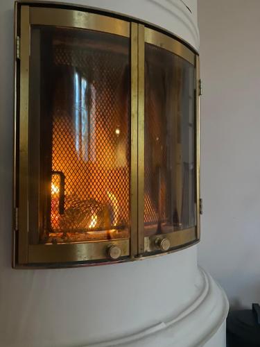 a fire oven is on a wall at Wooden house in Käpylä in Helsinki