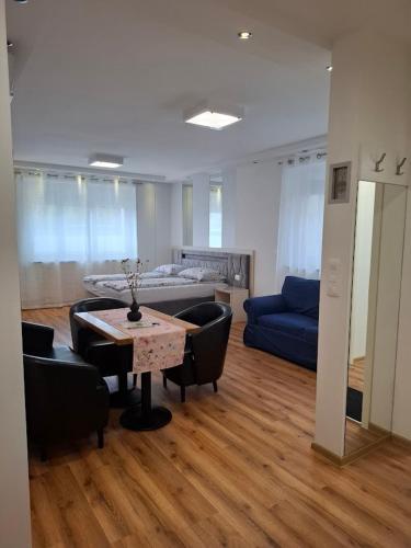a living room with a table and chairs and a couch at Vila Ema Apartments and Rooms in Ljubljana